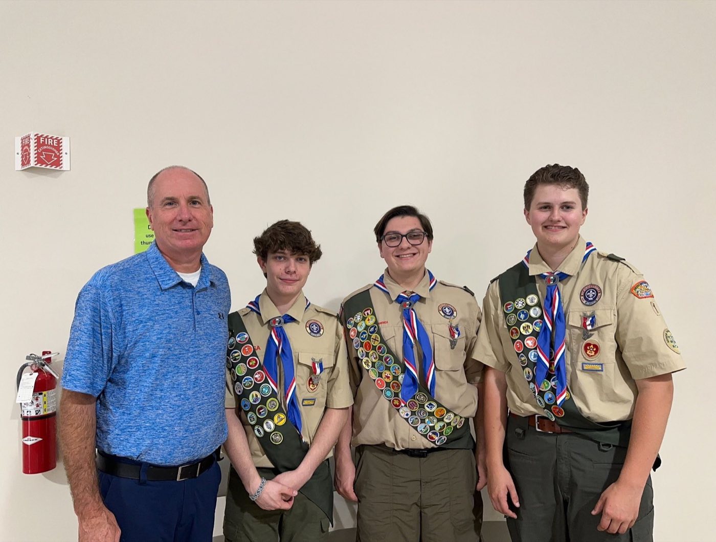 Paul Rickard congratulating three local Eagle Scouts
