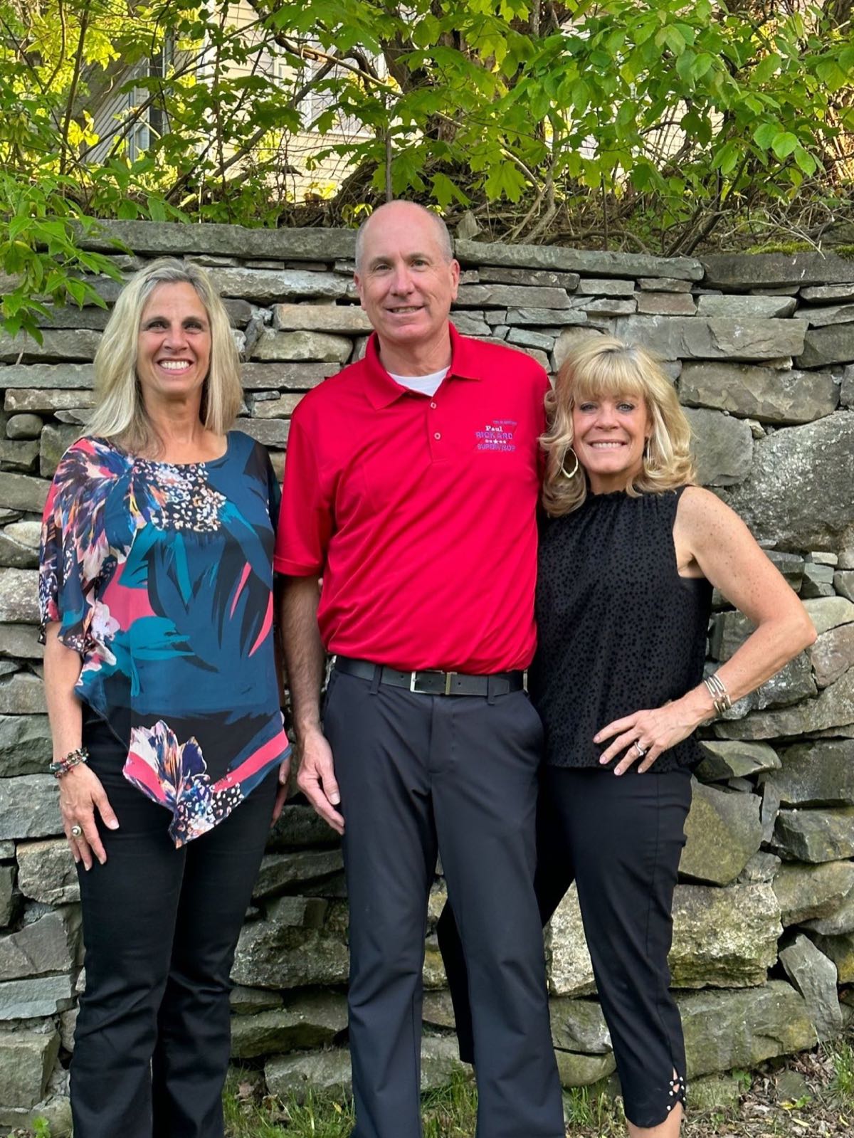 Paul Rickard with two community supporters