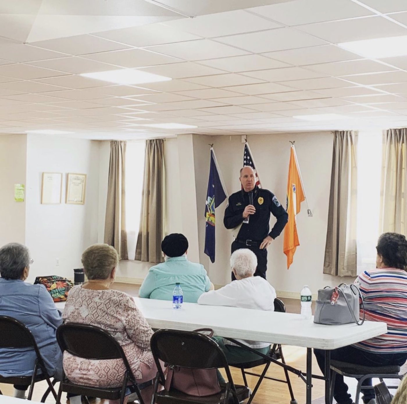 Police Chief Paul Rickard speaking with local senior residents